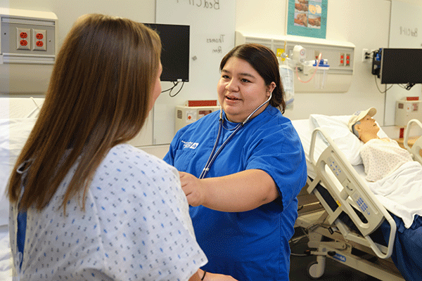 Two nursing students gain knowledge and skills in one of the Nursing Learning Resource Center skill labs at Indiana State University.